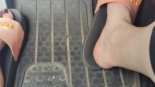 Revving the pedals of my mini Cooper with my pink Adidas slides