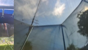 Tall girl in shorts jumping barefooted on a trampoline (slowed down) bottom view